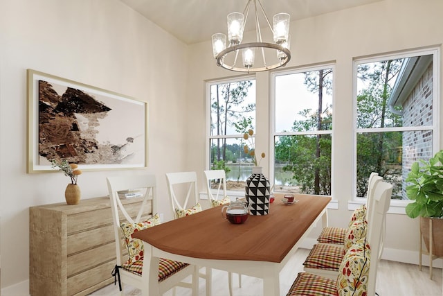 6795 Palace Dr, Lumberton, TX 77657 - dining area with baseboards, an inviting chandelier, and wood finished floors