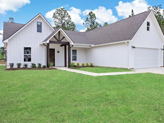 modern inspired farmhouse with a garage and a front lawn