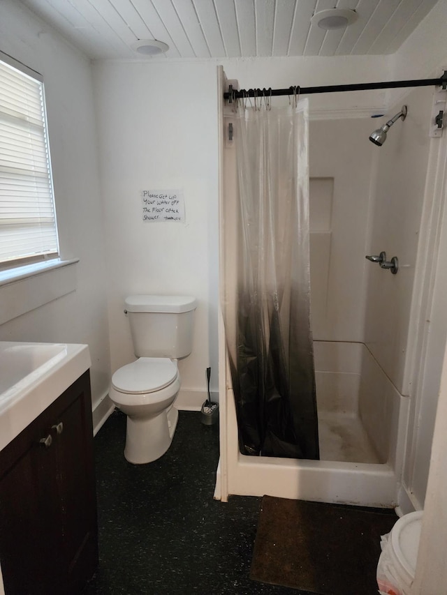 bathroom featuring vanity, curtained shower, and toilet