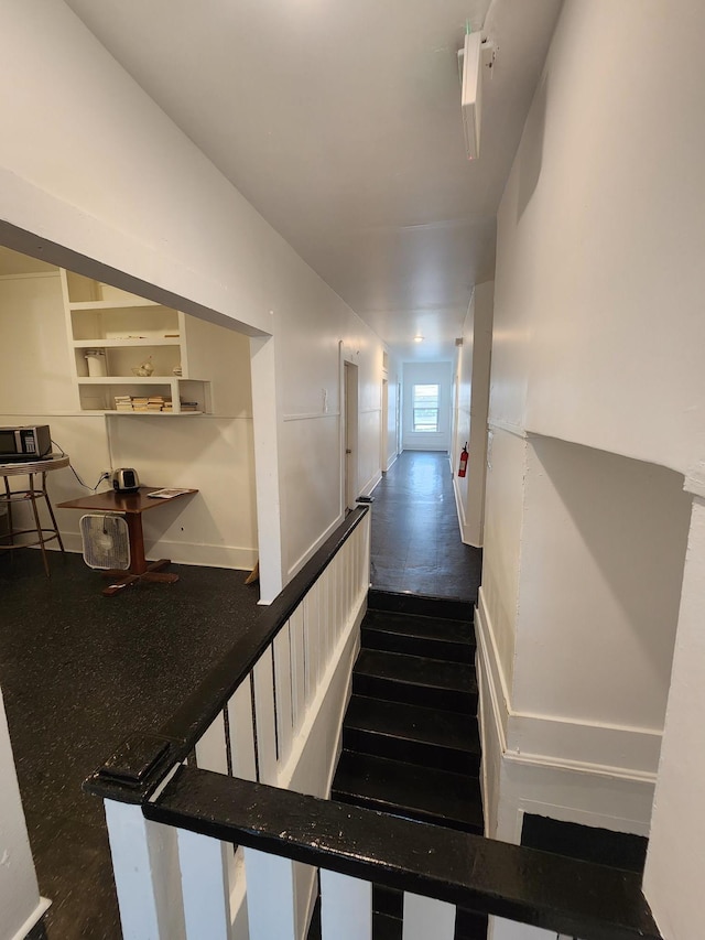 stairs featuring hardwood / wood-style floors