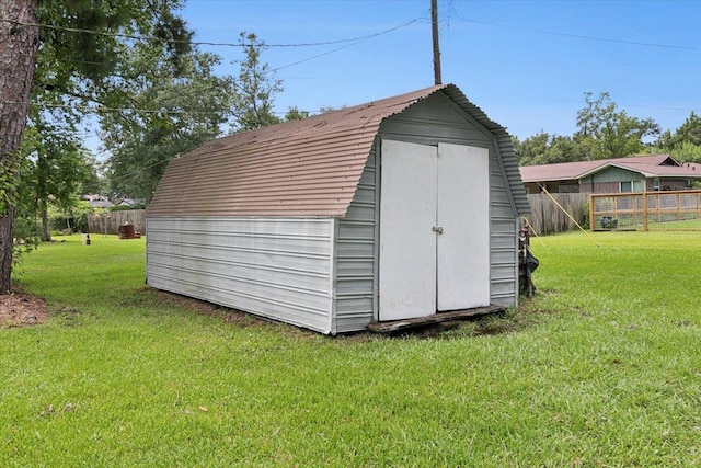 view of outbuilding with a lawn