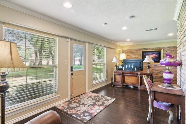 office space with a textured ceiling, dark hardwood / wood-style floors, and ornamental molding