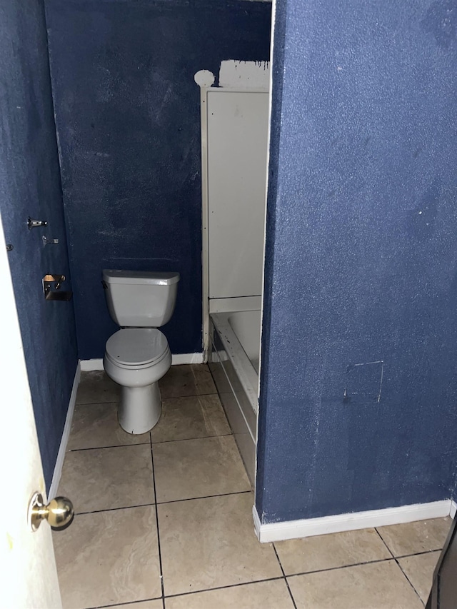 bathroom with tile patterned flooring and toilet