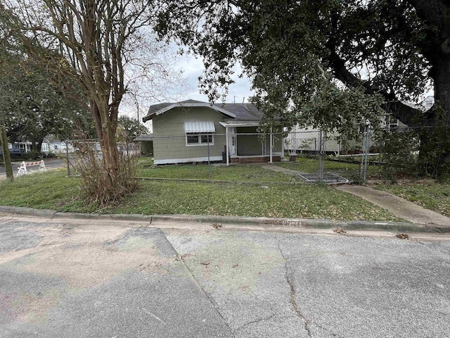 bungalow-style home with a front lawn