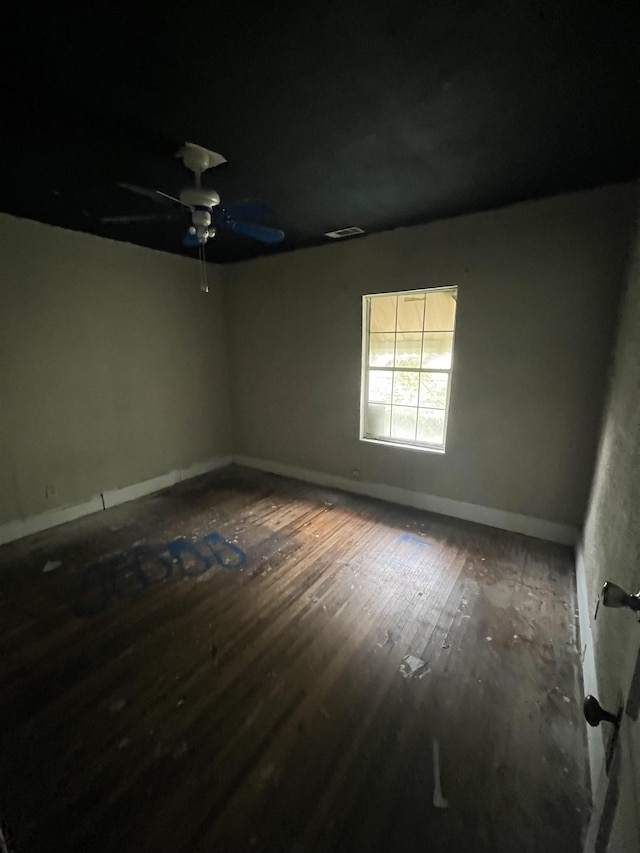 empty room with ceiling fan and hardwood / wood-style flooring