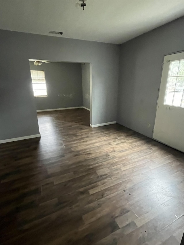 spare room featuring dark wood-type flooring