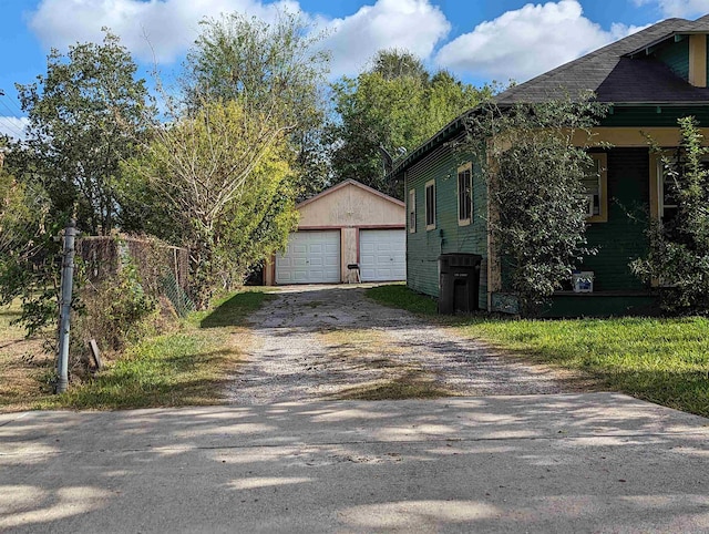 view of side of property featuring an outbuilding and a garage