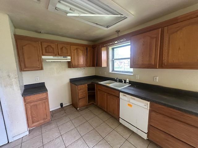 5935 Falcon Ln, Beaumont, TX 77708 - kitchen with dishwasher, a sink, light tile patterned floors, and dark countertops