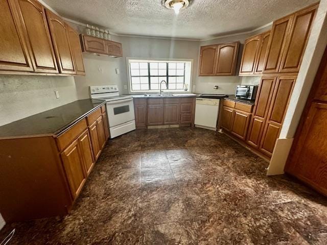 kitchen with white appliances, sink, and a textured ceiling