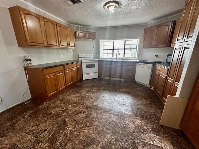 kitchen featuring sink, a textured ceiling, and white appliances