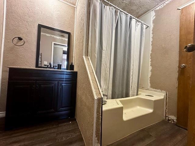 bathroom featuring wood-type flooring, shower / tub combo, and vanity