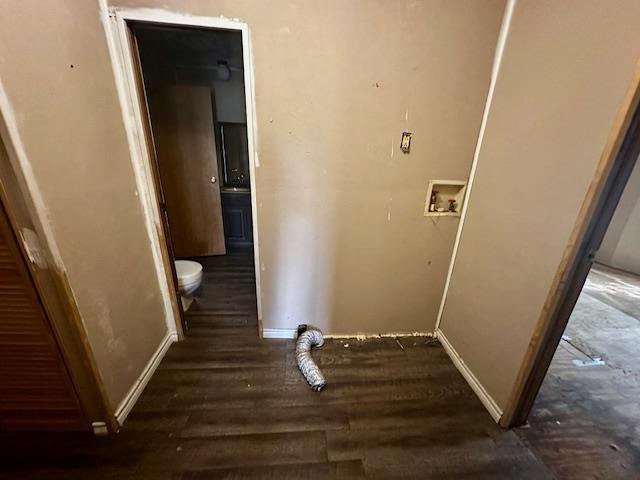 clothes washing area featuring washer hookup and dark wood-type flooring