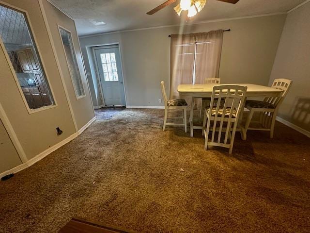 unfurnished dining area with carpet floors, ornamental molding, and ceiling fan