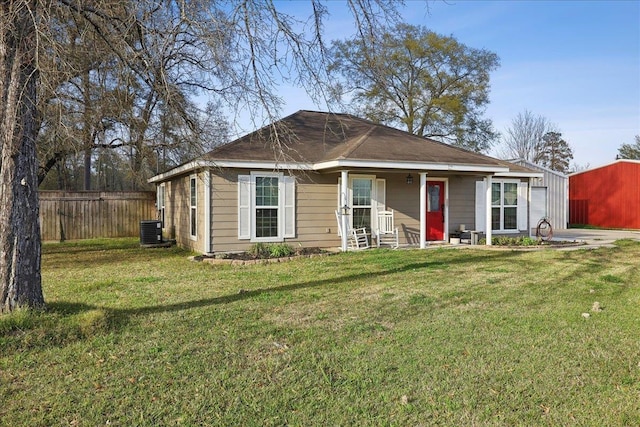 view of front of home featuring cooling unit, a front yard, and fence