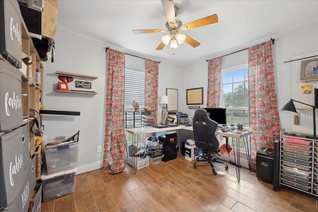 home office featuring baseboards, a ceiling fan, and wood tiled floor