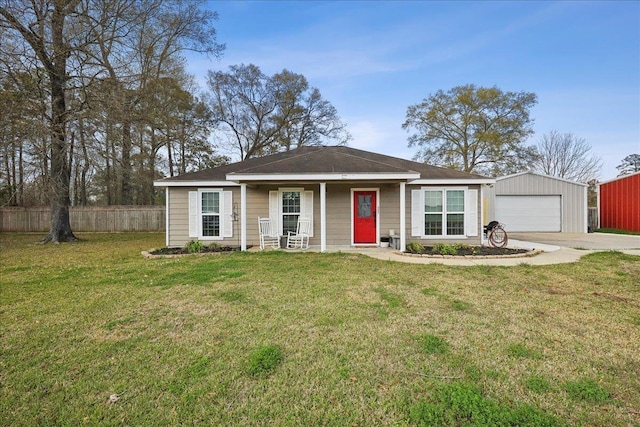 ranch-style home with a front lawn, a detached garage, fence, and an outdoor structure