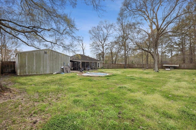 view of yard featuring an outbuilding and a fenced backyard