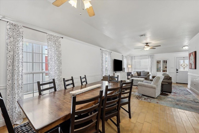 dining room featuring ceiling fan, visible vents, light wood-style flooring, and ornamental molding