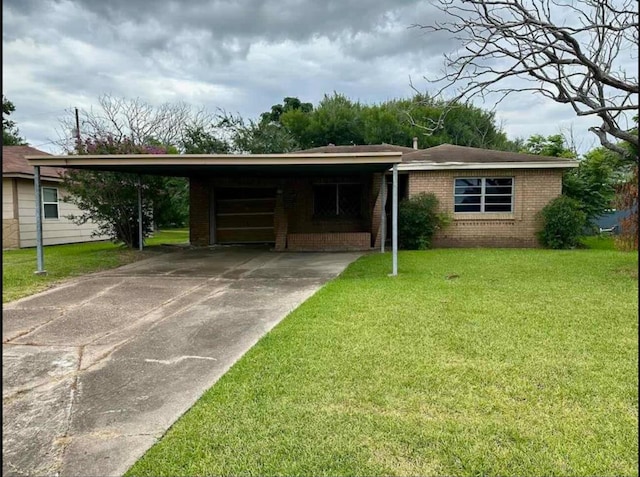 single story home with brick siding, a front lawn, driveway, and a carport