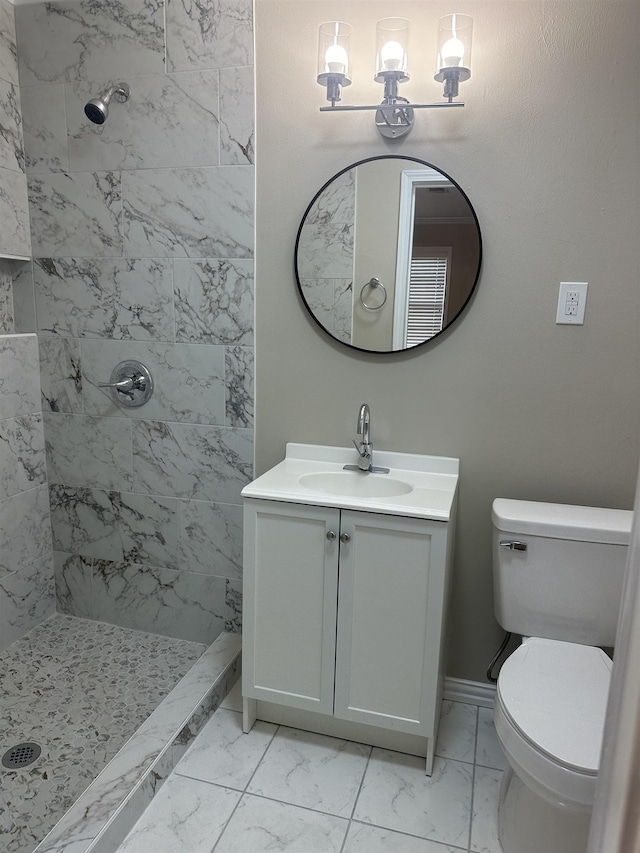 bathroom featuring toilet, a shower stall, marble finish floor, and vanity