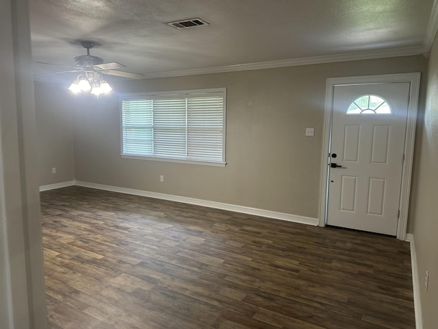 2938 Graves Ave, Groves, TX 77619 - foyer featuring ceiling fan, dark wood-style flooring, ornamental molding, and a textured ceiling
