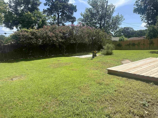 2938 Graves Ave, Groves, TX 77619 - fenced backyard with a deck