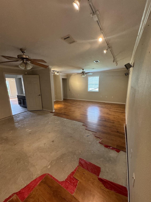 interior space with visible vents, rail lighting, baseboards, and a ceiling fan