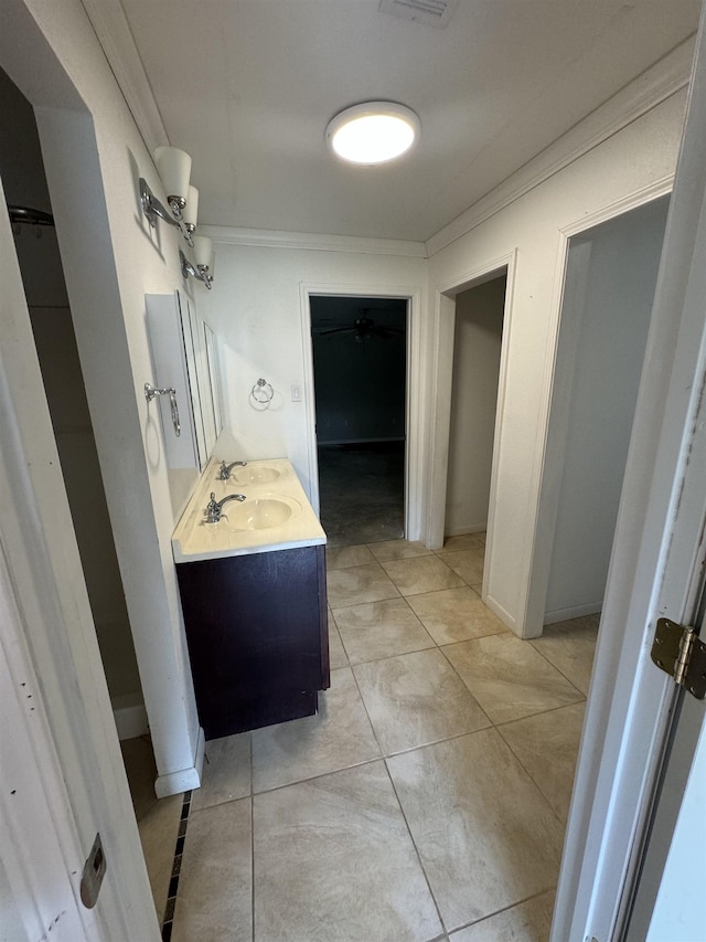 bathroom featuring vanity, ornamental molding, and visible vents