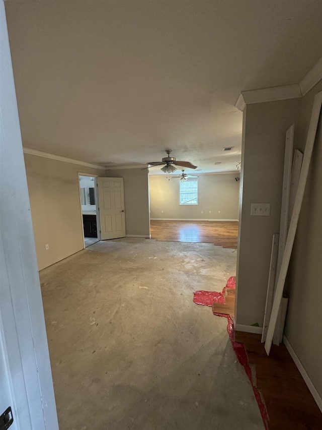 empty room featuring crown molding, baseboards, ceiling fan, and unfinished concrete floors