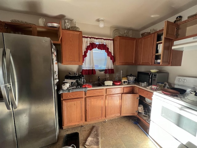 1928 Rev Dr Ranson Howard St, Port Arthur, TX 77640 - kitchen featuring freestanding refrigerator, white range with electric stovetop, black microwave, under cabinet range hood, and light countertops