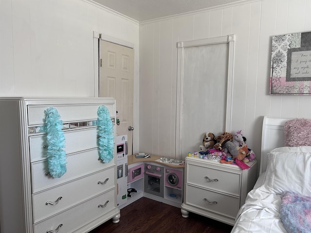 bedroom with dark wood finished floors and ornamental molding