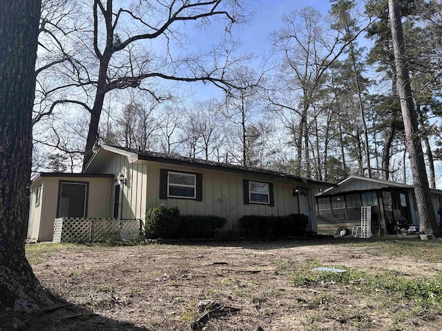 view of front of home featuring board and batten siding and a sunroom