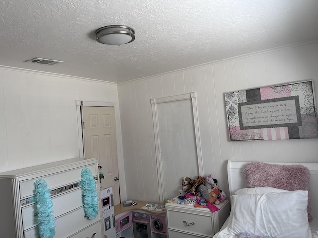 bedroom featuring visible vents and a textured ceiling