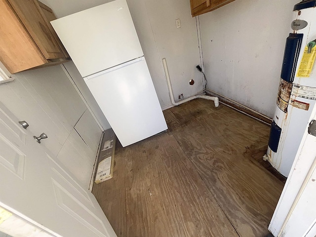 laundry room with wood finished floors and water heater