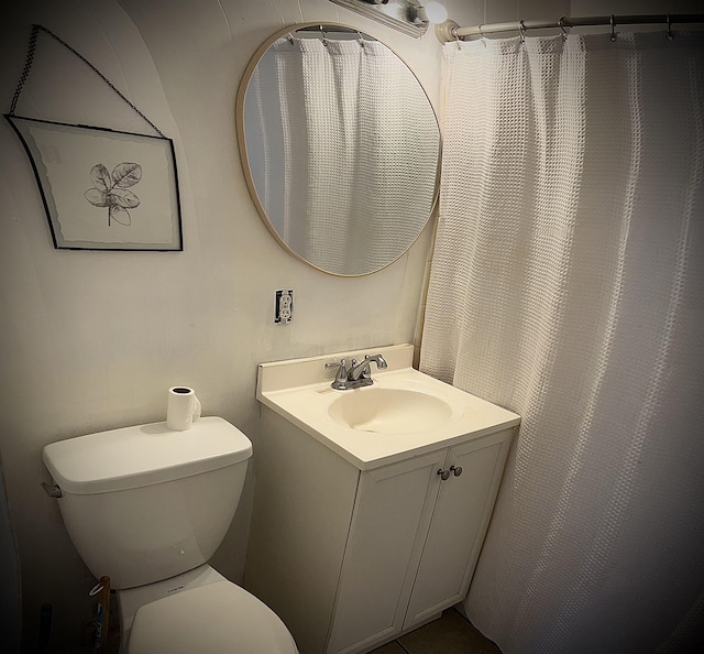 bathroom featuring toilet and vanity