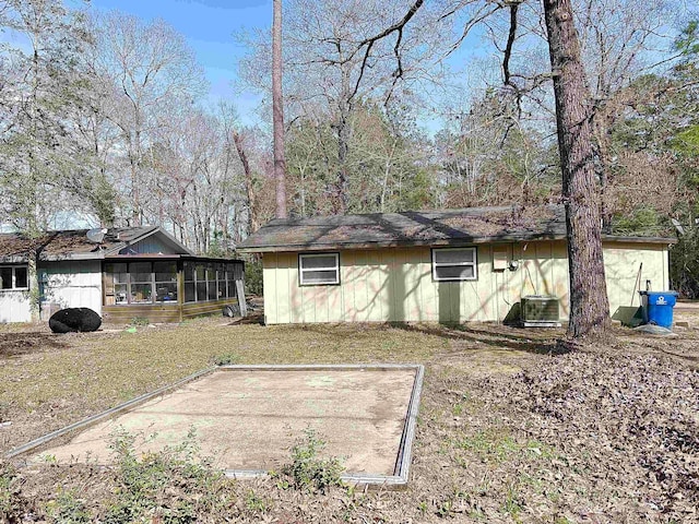 view of side of property with central AC and a sunroom