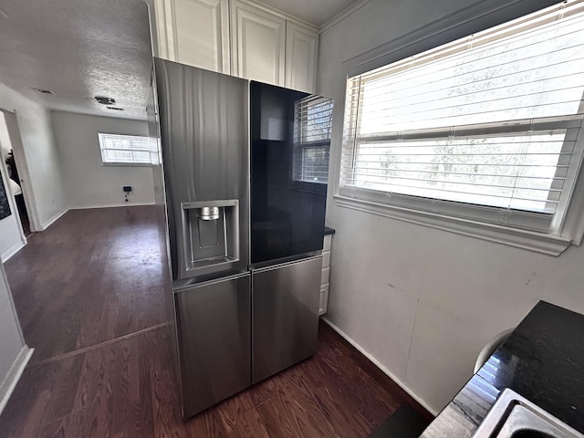 kitchen with baseboards, a textured ceiling, stainless steel fridge, and wood finished floors