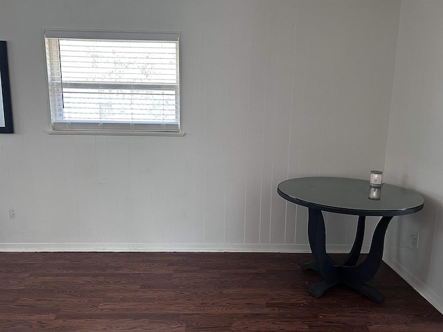 interior space with baseboards and dark wood-type flooring