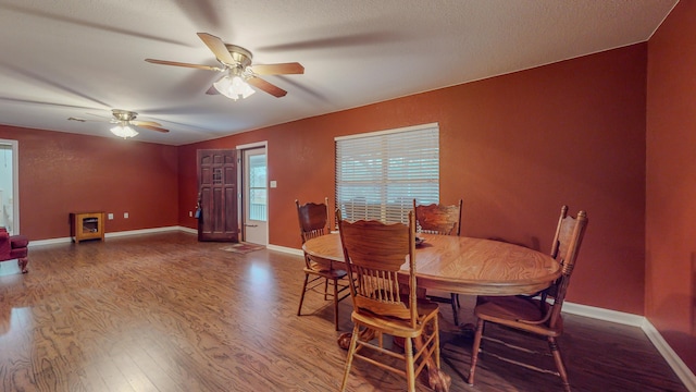 dining room with hardwood / wood-style floors, a textured ceiling, and ceiling fan