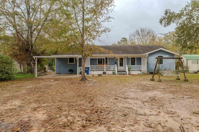 view of front of house featuring covered porch and a carport