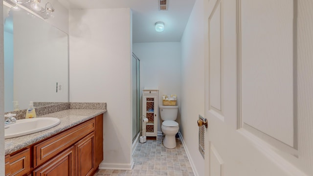 bathroom featuring vanity, toilet, and walk in shower