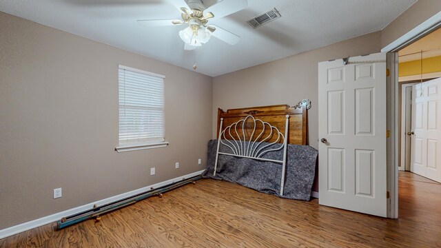 bedroom featuring ceiling fan and wood-type flooring