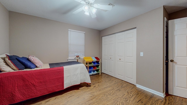 bedroom featuring hardwood / wood-style floors, ceiling fan, and a closet