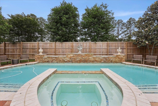 view of pool featuring fence and a pool with connected hot tub