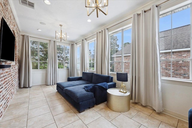 sunroom with visible vents and a chandelier