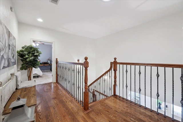 stairway featuring recessed lighting, visible vents, and wood finished floors