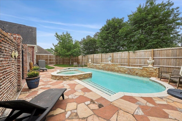 view of pool with a patio, a fenced backyard, a pool with connected hot tub, and cooling unit