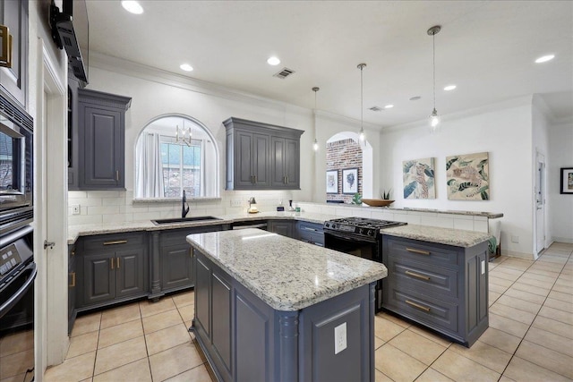 kitchen with a sink, a center island, a peninsula, visible vents, and black appliances