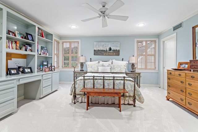 carpeted bedroom featuring ceiling fan, crown molding, and built in desk