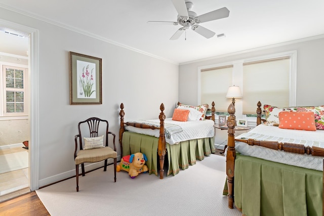 bedroom featuring connected bathroom, ceiling fan, crown molding, and hardwood / wood-style flooring